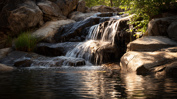 16 Natural Stone Waterfall for Hillside Beauty and Relaxation 4 Gentle waterfall on hillside with smooth stones and calm water sound effect.
