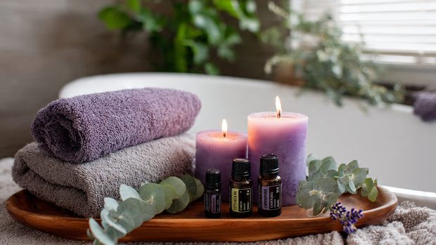 16 Luxurious Bathroom Design Ideas for a Spa-Like Retreat 8 Aromatherapy setup with candles, essential oils, and soft towels in a spa bathroom.