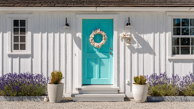 Beach cottage with turquoise front door and seashell decor.